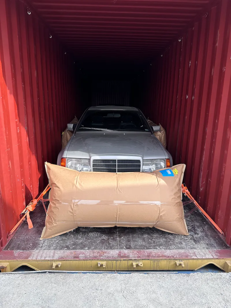 Classic Mercedes in red container shipping Dubai